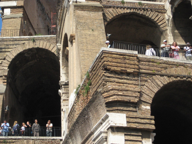 Cave dwellers close-up of arches and visitors at colosseum
