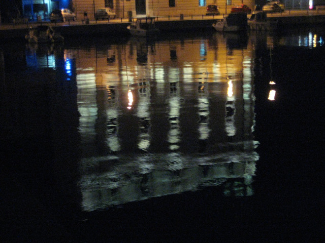 Reflection of harbormaster's office reflection of floodlit building