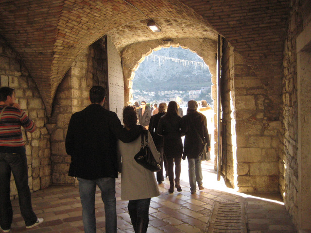 The Sea Gate people leaving city through old stone tunnel