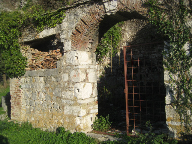 high over the old city rusty gate to recess in stone wall