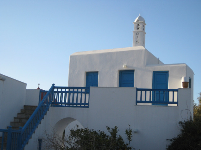 Mykonos skyline white house with some kind of spire behind it