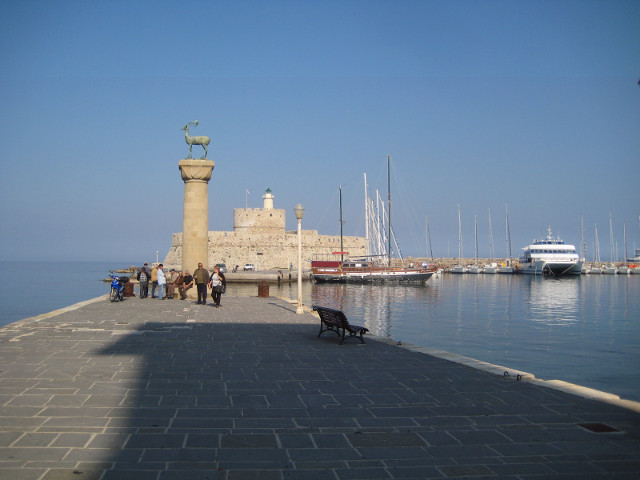 Where The Colossus once stood Narrow harbor entrance, flanked by fort and column