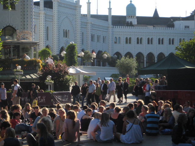 Late Afternoon lawn filled with sitting people