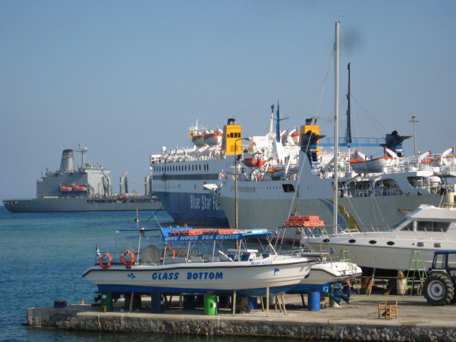Looking Back at the boat that brought me. harbor with a large ship