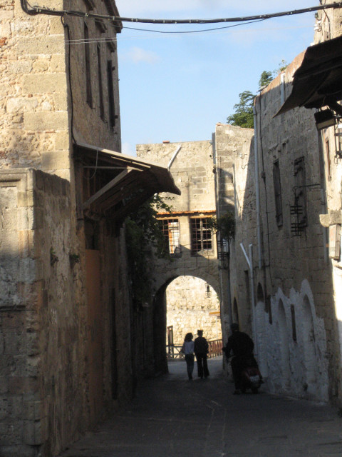 Old Street With Couple Couple silhouetted in gate of narrow old street