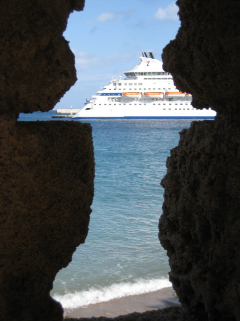 Archer's view of a cruise ship Ship framed by slot in stone parapet