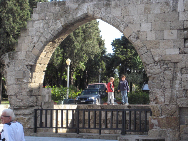 Kids and Arch 4-5 year olds, framed by gothic-pointed stone arch