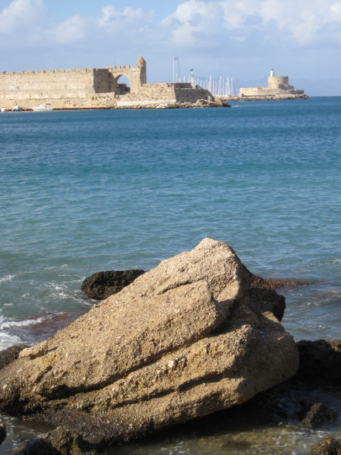 Across the Harbor Booulder in the bay, distant fort and yacht masts