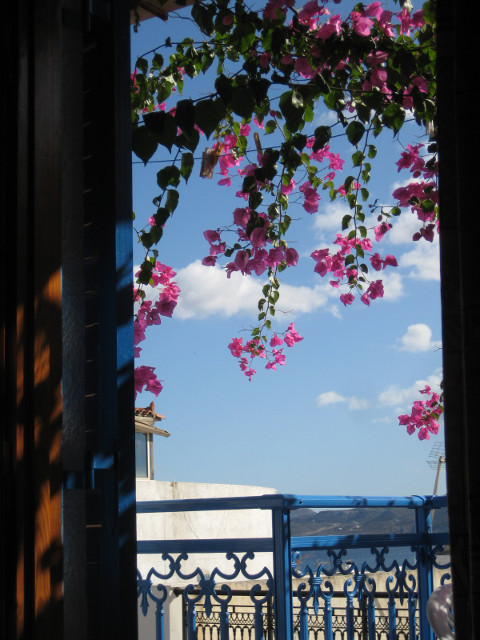 View, sitting in bed door, balcony, ocean between bui;ldings