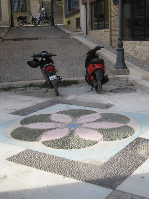 Flower Mosaic Flower mosaic in pebbles in sidewalk