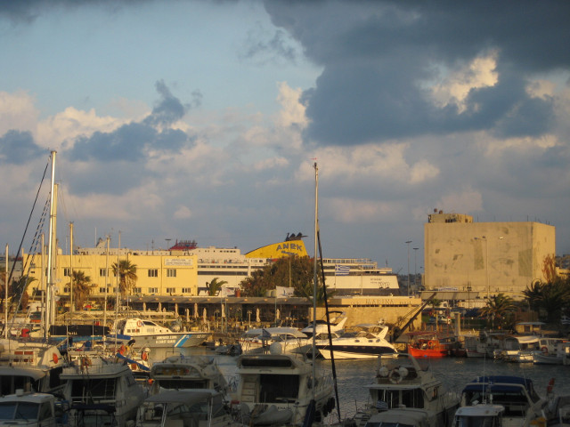View toward Ferry Port chaotic masts,, concrete buildings, glimpse of ferry