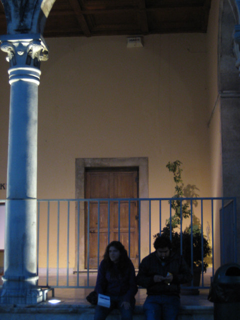 Hanging Out at Night silhouette of couple sitting on porch of municipal building