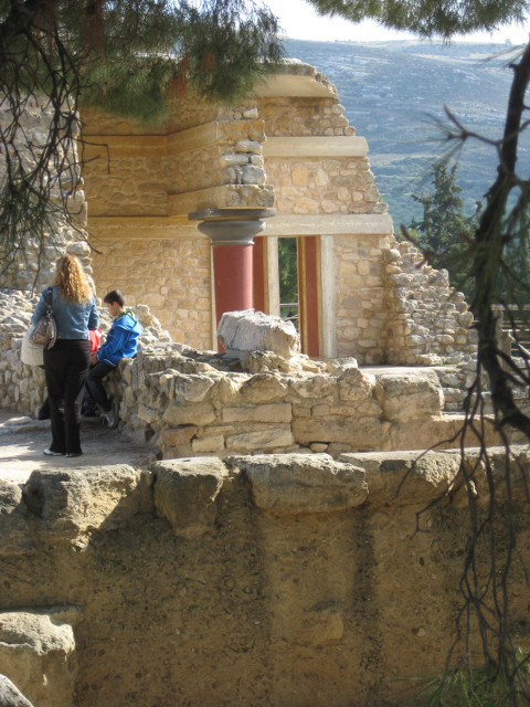 Fellow Tourists Couple atop stone bastion, in front of partly-restored colonnade