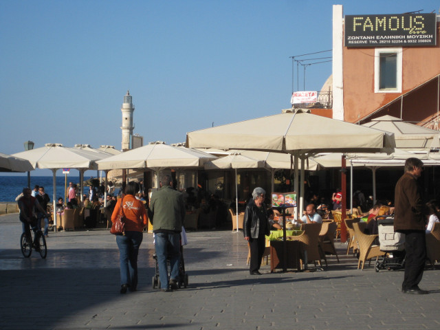 Reaching the Harbor several umbrella-covered outdoor cafes, glimpse of water