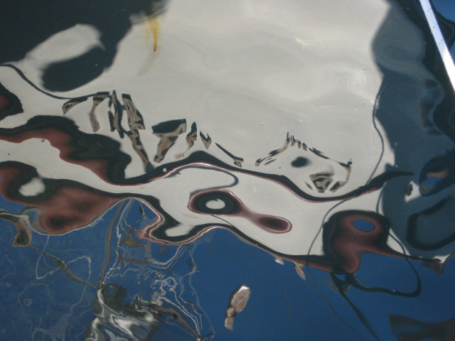 Boat in Water wobbly reflection of sailboat
