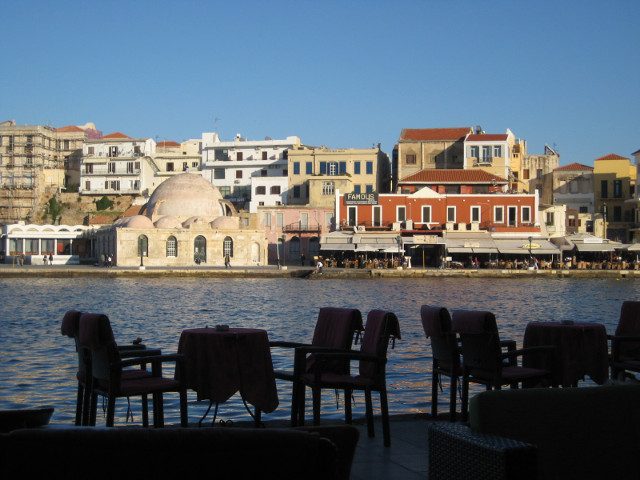 Late Afternoon silhouettes of cafe chairs against harbor
