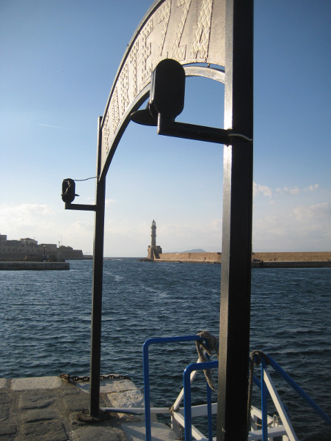 Lighthouse distant lighthouse, framed obliquely by arch