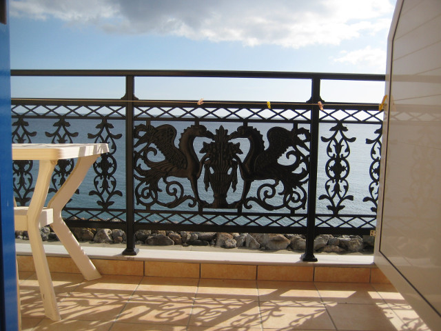Out the Door balcony rail, sea, sky, edge of PVC table