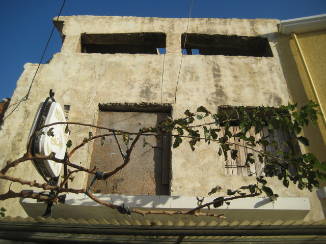 Derelict upper floor and empty windows in concrete wall