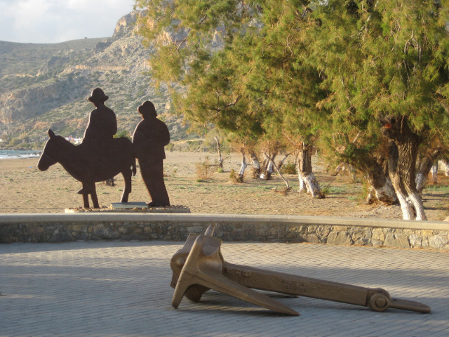 "The Traveller" sculpture - silhouette of two men, one on a burro