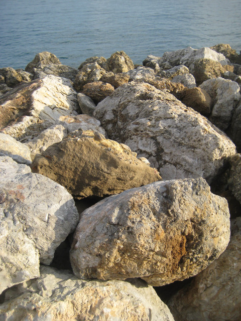 breakwater small boulders sloping down to calm sea