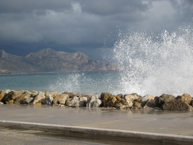Booming Wave surf breaking on breakwater