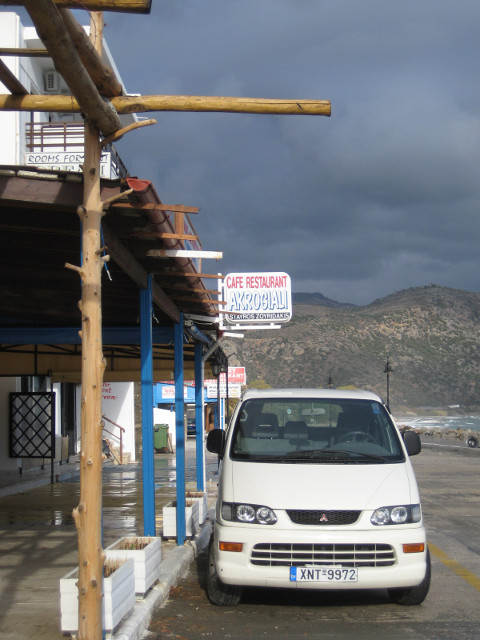Parked White Car dark clouds behind white car