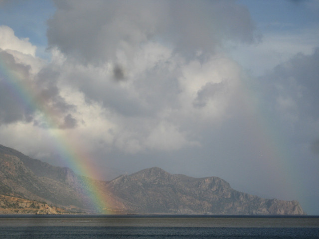 Double Rainbow nested rainbows overr sea in front of an arm of the White Mts