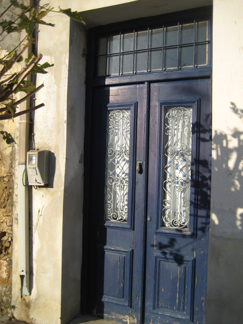 What's Behind that Blue Door closed blue double door in off-white wall