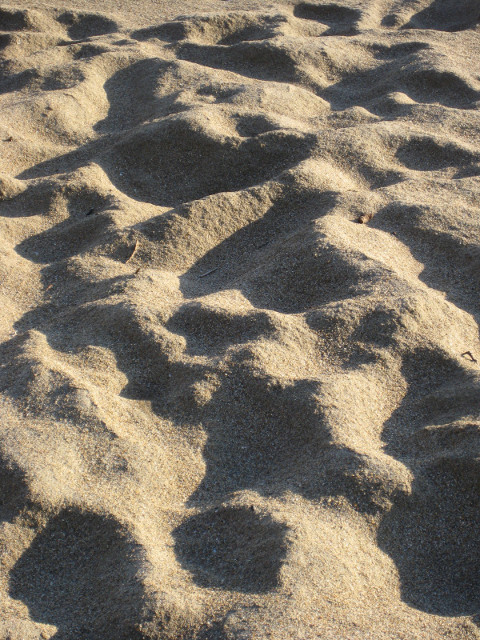 Sand Shadows low-lighted beach sand, walked--in
