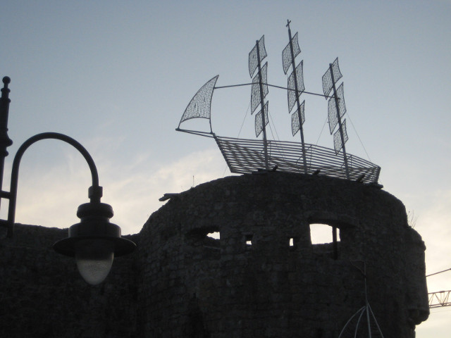Cheshire turret, with grin silhouette of tower with ship sculpture on top