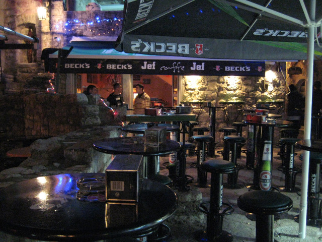 Jef Beck's ?!? empty outdoor bar, Awning reads "Caffe Jef" & a Beck's bbeer logo
