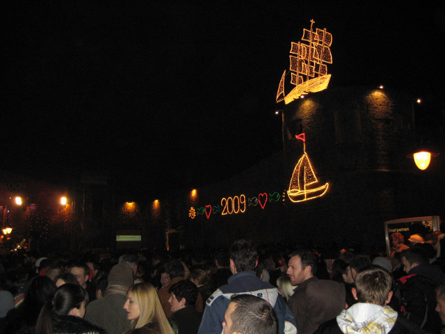 Lights 'n folks crowd of celebrants in front of light string display