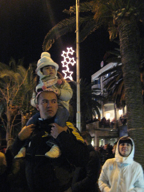 High riding kid todddler atop father's shoulders