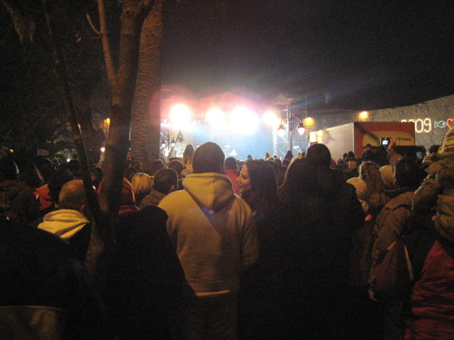 From the back lots of people, distant stage
