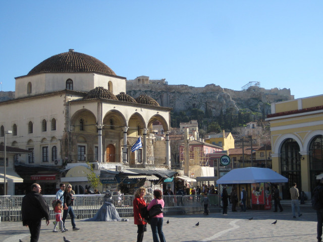Monastiraki Square plaza with tourists, performers, and a church