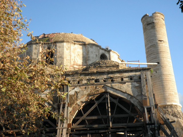 Dead Mosque Wooden scaffolding propping up shell of former mosque, minaret broken off at roof height