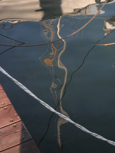 Wiggly Mast sailboat mast reflected in water