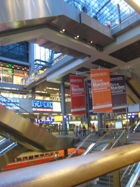 Berlin Hauptbahnhof Escalators, shops, and a glimpse of a train