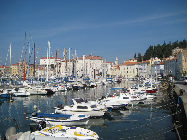 Piran Harbor Rows of yachts, Venetian buildings along waterfront