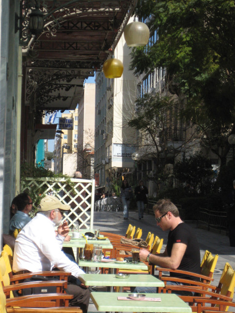 Athens Lunchtime Line of outdoor tables, some with a customer
