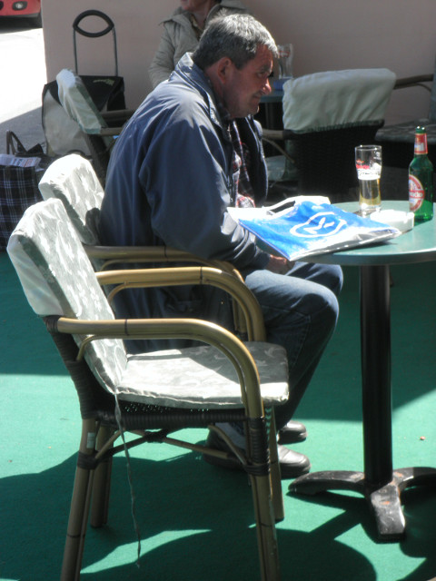 old guy old man at outdoor cafe table