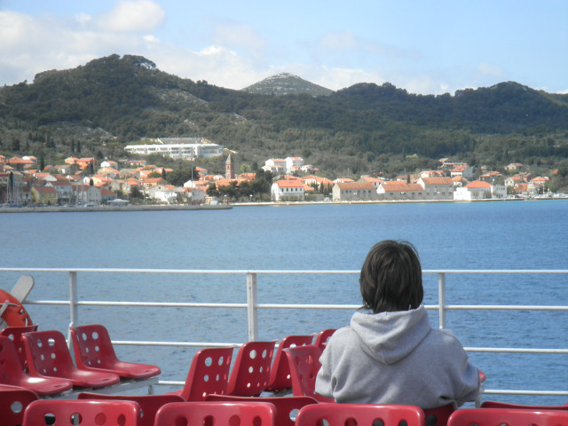 Uglian Island mountainous island across water from ship deck