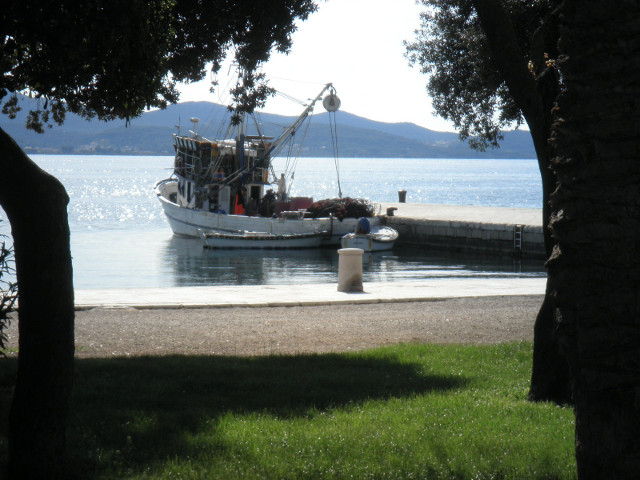 looking toward Uglian island park, waterfront with boat, background island