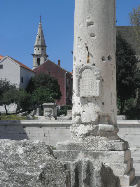 pillar and tower ancient column, medieval church tower in distance