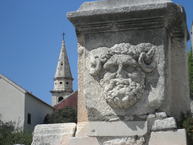 horny old guy ancient stone face with curly horns