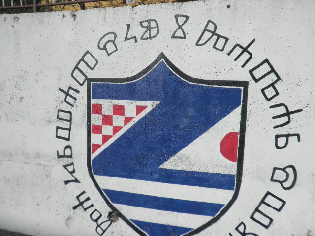 glaglitic alphabet glagolitic script surrounding a coat of arms, painted on a wall