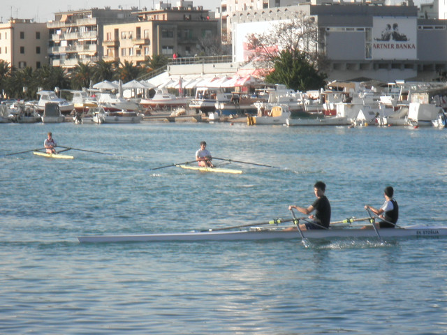 Rowers crew shells on inner harbor