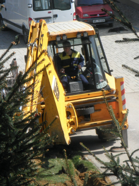 construction bird>'s eye view of a yellow back hoe at work