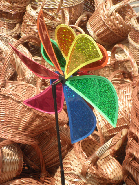 spin colorful pinwheel in front of wicker baskets
